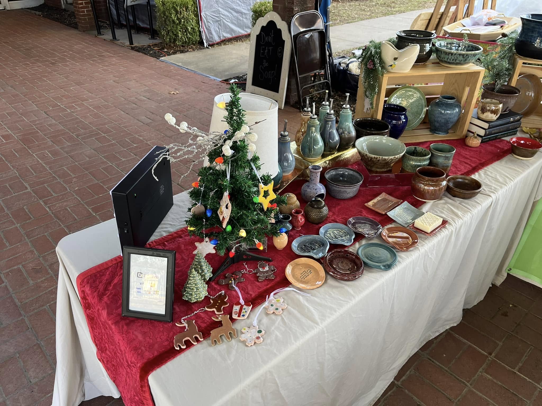 A Mud to Market display of handmade pottery at a local craft market